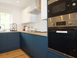 A kitchen with a sink, kettle, microwave and oven at Folly View in Cambrose near Illogan