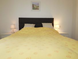 A bedroom with a bed and nightstands at Folly View in Cambrose near Illogan