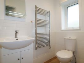 A bathroom with a sink, toilet and a heated towel rail at Folly View in Cambrose near Illogan