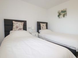 A bedroom with two single beds at Folly View Cambrose near Illogan