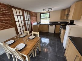 A kitchen with a dining table and chairs at The Studio in Marsham near Aylsham