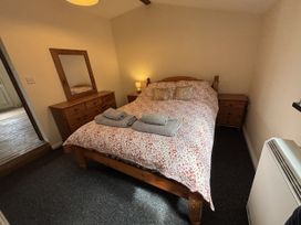A bedroom with a bed and bedside tables at The Studio in Marsham near Aylsham