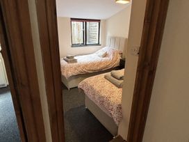 A bedroom with two beds and towels at The Studio in Marsham near Aylsham