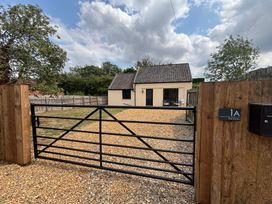 An exterior view of a house with a gravel driveway at The Studio in Marsham near Aylsham