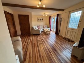 A living room with a sofa and a coffee table at The Studio in Marsham near Aylsham