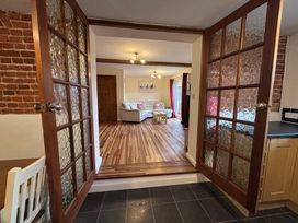 A living room seen through double doors at The Studio in Marsham near Aylsham
