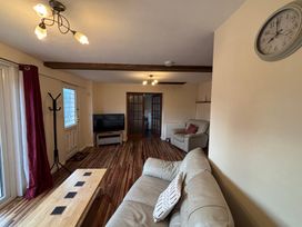 A living room with a sofa and television at The Studio in Marsham near Aylsham