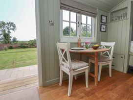 A dining area with a table and chairs at Shepherd's Hut in Wrexham