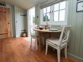 A dining room with a table and chairs at Shepherd's Hut in Wrexham