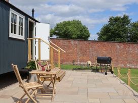 An outdoor area with a table and chairs at Shepherd's Hut in Wrexham