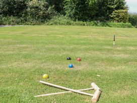 Croquet balls and mallets on grass in an outdoor area at Shepherd's Hut Wrexham