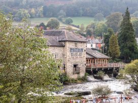 A mill by the river at The Garden Hut in Wrexham