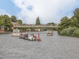 Boats on a river with a bridge in the background at The Garden Hut in Wrexham