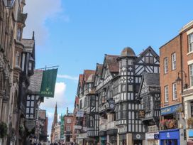 A street view with historic buildings and shops in Wrexham