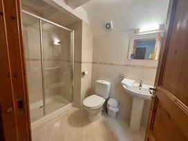 A bathroom with shower, toilet, and sink at Acorn Lodge Finlakes Holiday Park near Chudleigh