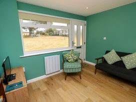 A living room with a chair and sofa at No 157 Sandown Bay Holiday Chalet 'Field View' Sandown
