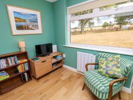 A living room with a tv and books at No 157 Sandown Bay Holiday Chalet 'Field View' Sandown