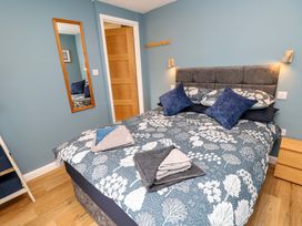 A bedroom with a bed and mirror at No 157 Sandown Bay Holiday Chalet 'Field View' in Sandown