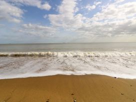 A beach with sand and waves at No 157 Sandown Bay Holiday Chalet 'Field View' Sandown