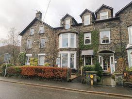 A building with ivy and sign at Norwood House in Ambleside