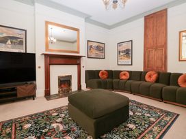 A living room with a sofa and a television at Norwood House in Ambleside