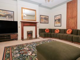 A living room with a television and a fireplace at Norwood House in Ambleside