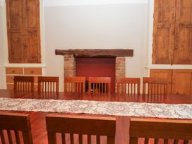 A dining room with a long table and chairs at Norwood House in Ambleside