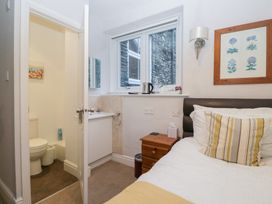 A bedroom with a bed and attached bathroom at Norwood House in Ambleside