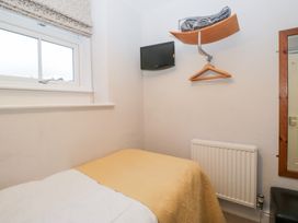 A bedroom with a bed and a television at Norwood House in Ambleside