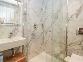 A bathroom with a shower, sink, and toilet at Norwood House in Ambleside