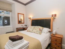 A bedroom with a bed and bedside table at Norwood House in Ambleside