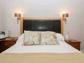 A bedroom with a bed and bedside table at Norwood House in Ambleside