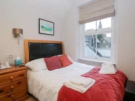 A bedroom with a bed and bedside table at Norwood House in Ambleside