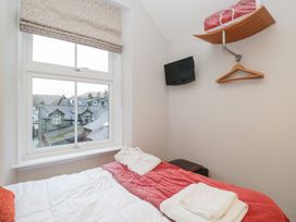 A bedroom with a bed and television at Norwood House in Ambleside