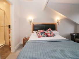 A bedroom with a bed and shower area at Norwood House Ambleside
