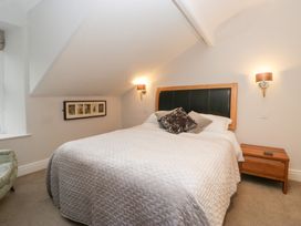 A bedroom with a bed and bedside table at Norwood House in Ambleside