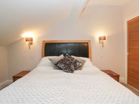A bedroom with a bed and bedside table at Norwood House in Ambleside