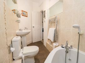 A bathroom with a toilet, sink, and bathtub at Norwood House in Ambleside