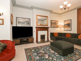 A living room with a sofa and television at Norwood House Ambleside