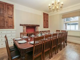 A dining room with a large table set for meals at Norwood House Ambleside