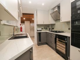 A kitchen with a sink, stove, and refrigerator at Norwood House in Ambleside