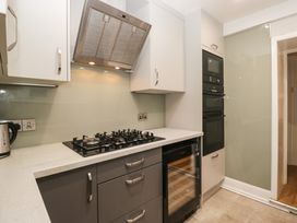 A kitchen with a gas stove and oven at Norwood House in Ambleside