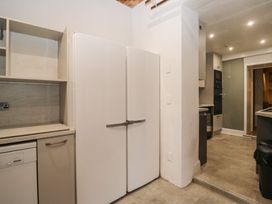 A kitchen with refrigerator and cabinets at Norwood House in Ambleside