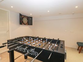 A game room with a foosball table and dartboard at Norwood House in Ambleside