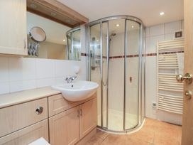 A bathroom with a shower and sink at Norwood House in Ambleside