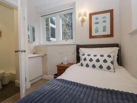 A bedroom with a bed and attached bathroom at Norwood House Ambleside