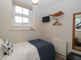 A bedroom with a bed and television at Norwood House in Ambleside