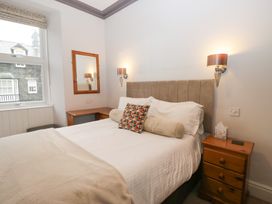 A bedroom with a bed and desk at Norwood House in Ambleside