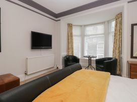 A bedroom with a bed and seating area at Norwood House in Ambleside