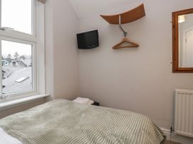 A bedroom with a bed and television at Norwood House in Ambleside